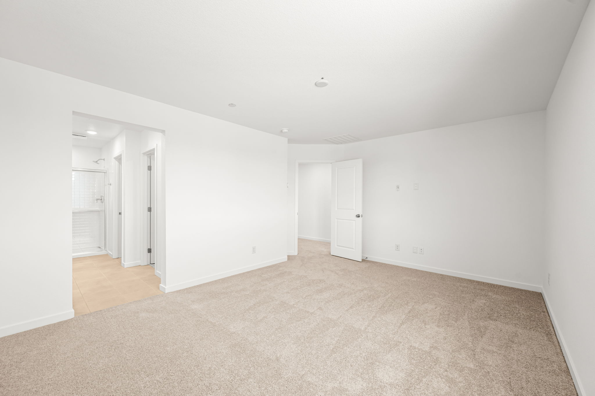 A long hallway with white doors.