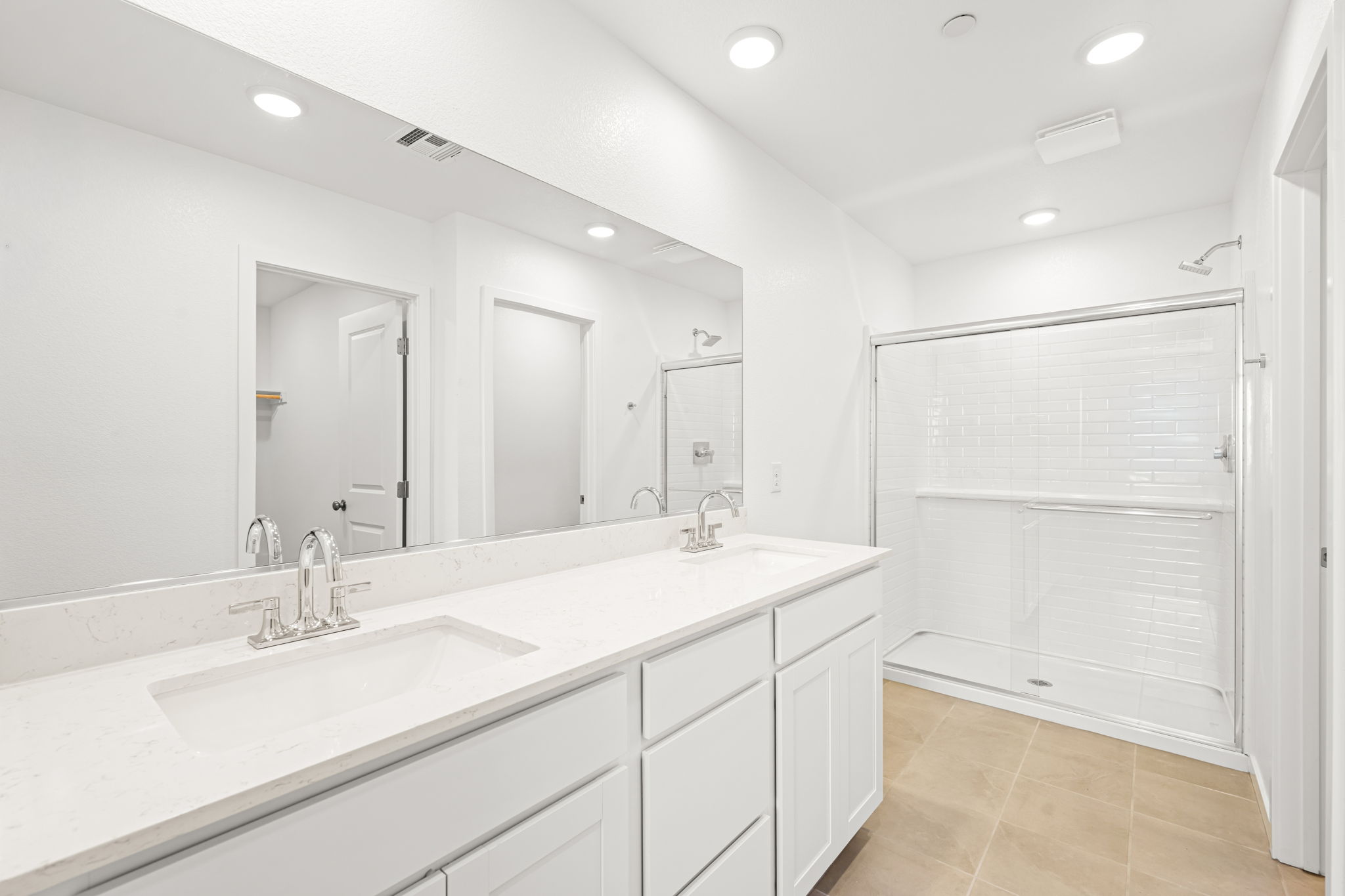 A bathroom with white cabinets.