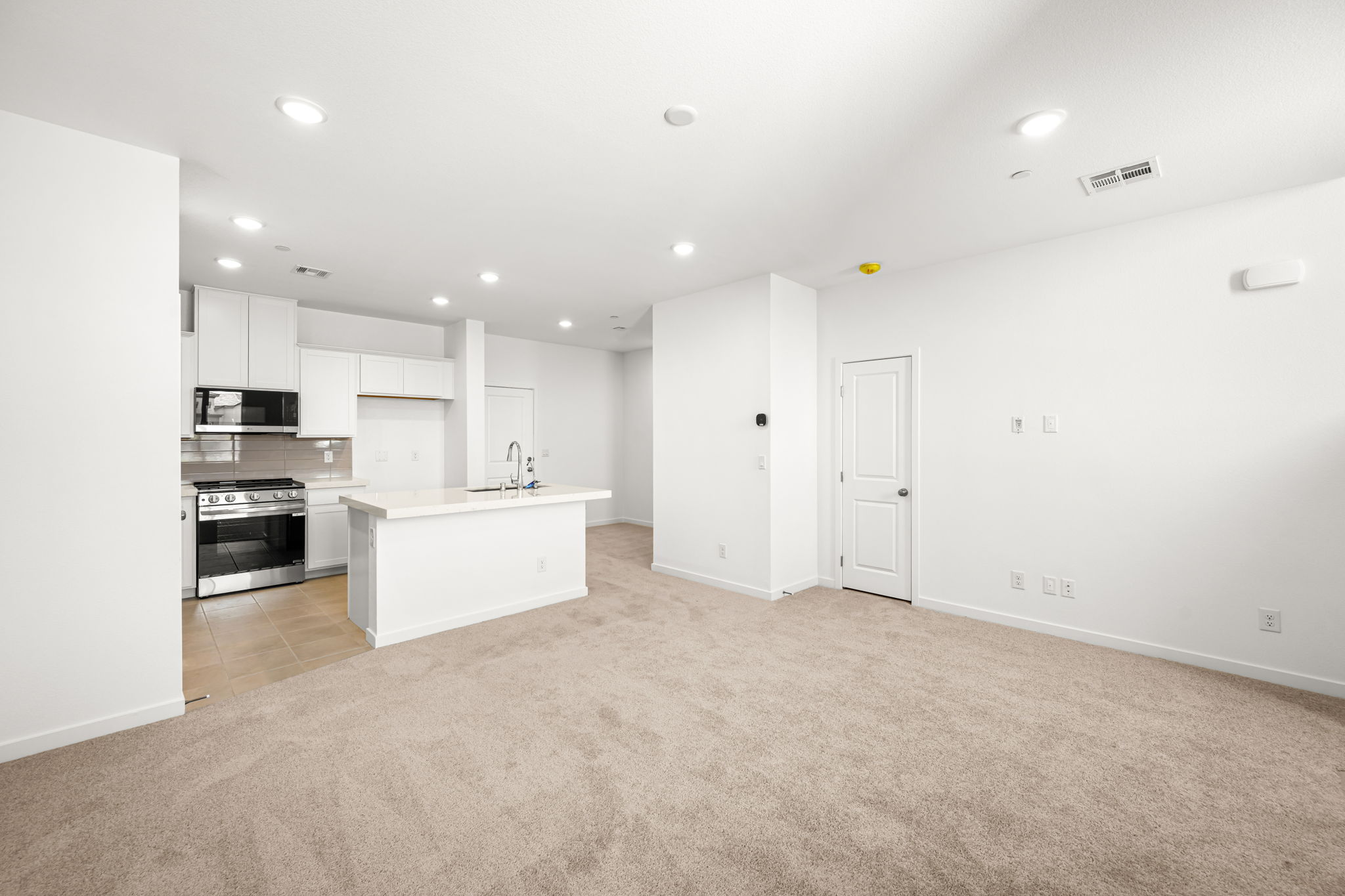 A large kitchen with white cabinets.