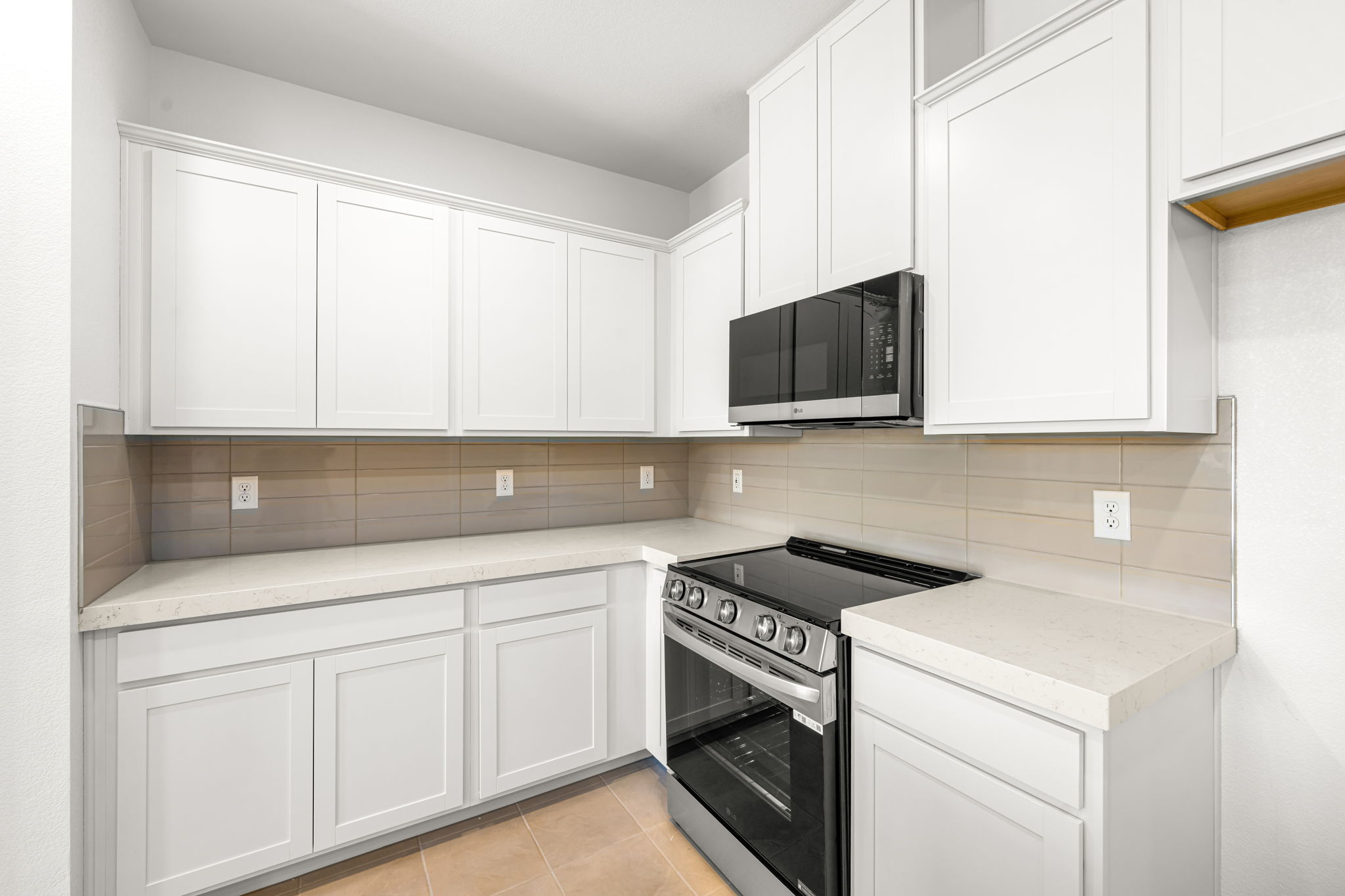 A kitchen with white cabinets.