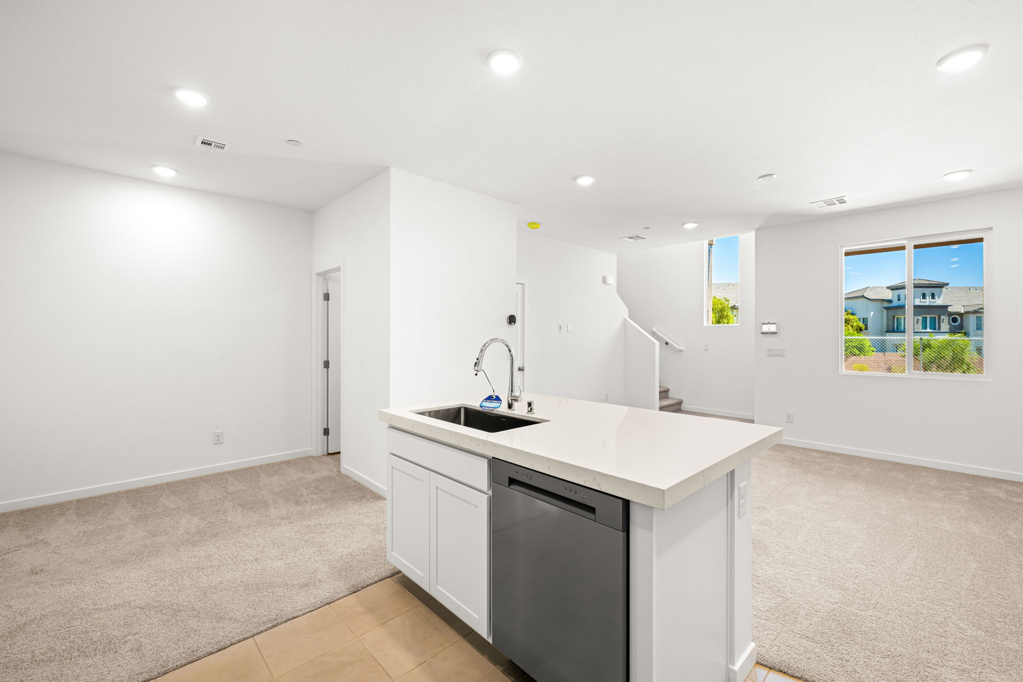 A kitchen with white cabinets.