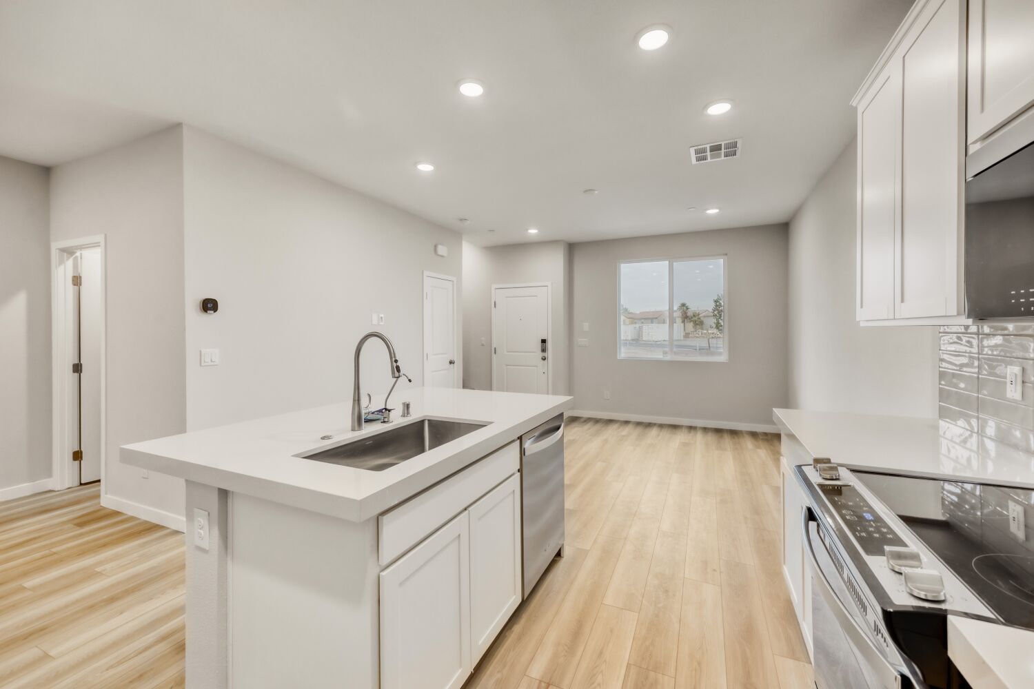 A kitchen with white cabinets.