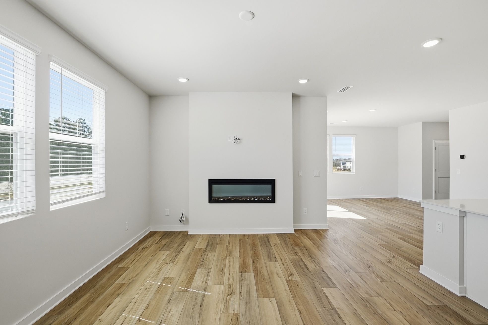 A room with a wood floor and white walls.