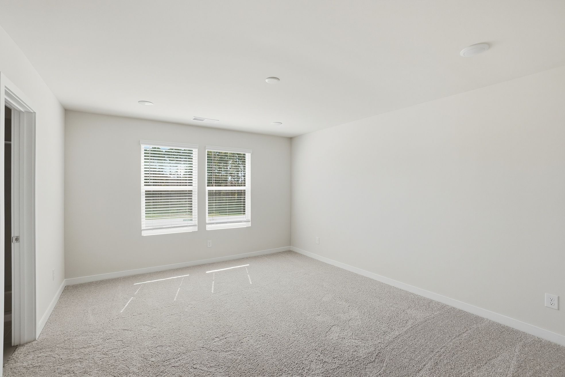 A room with a window and a door.