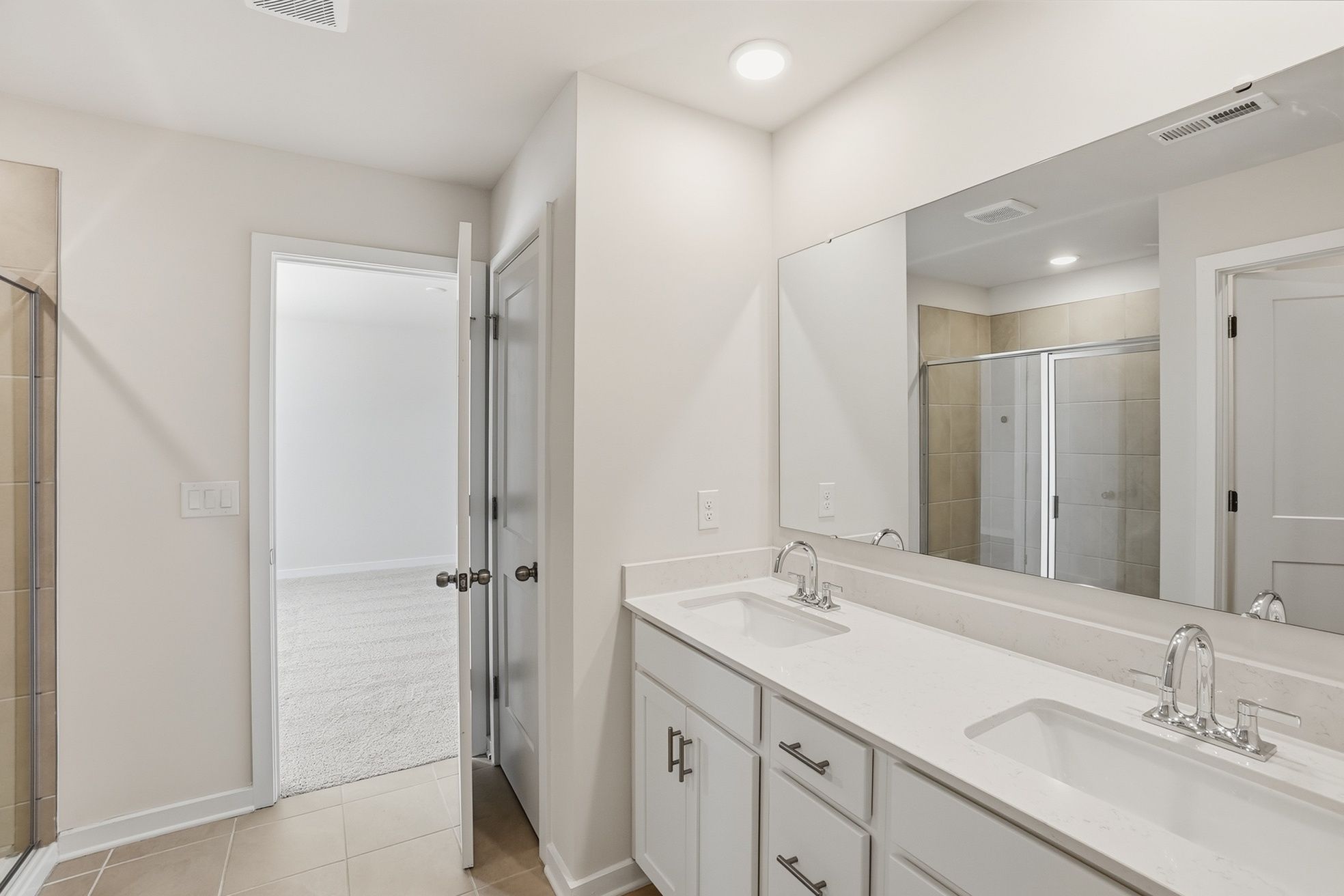 A bathroom with a large mirror.