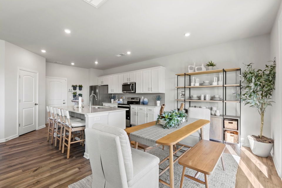 A kitchen with white cabinets.