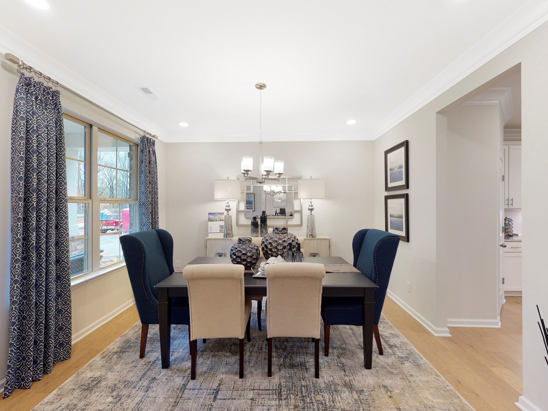 A dining room with a table and chairs.