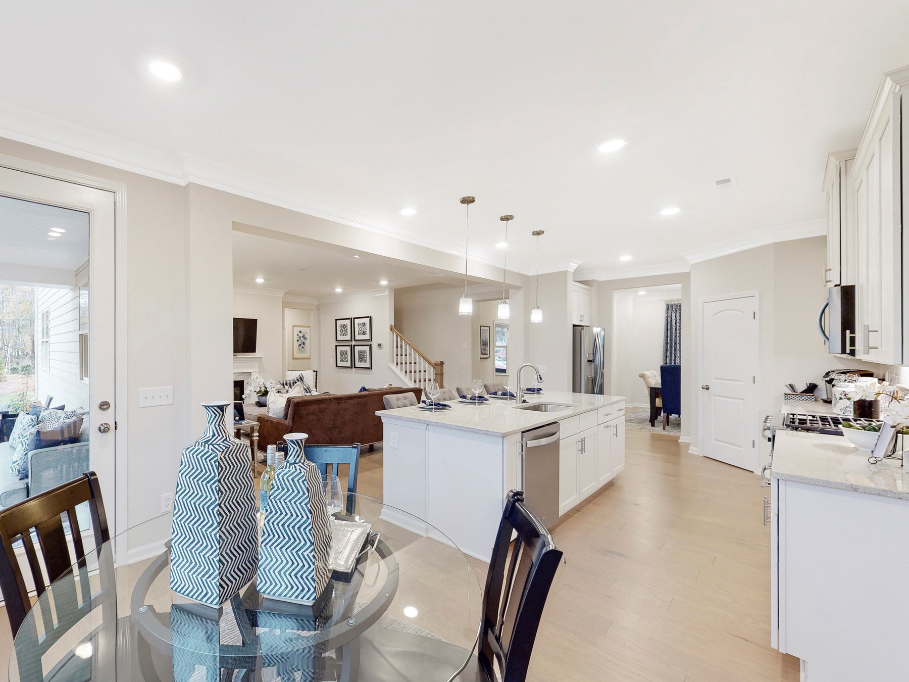 A kitchen with white cabinets.