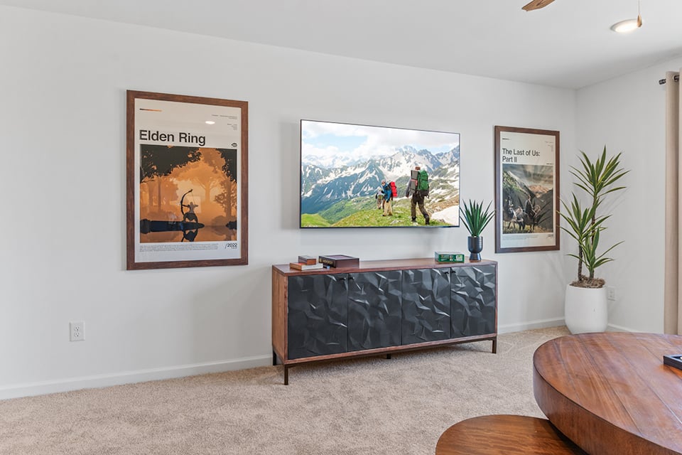 A room with a wall of paintings.