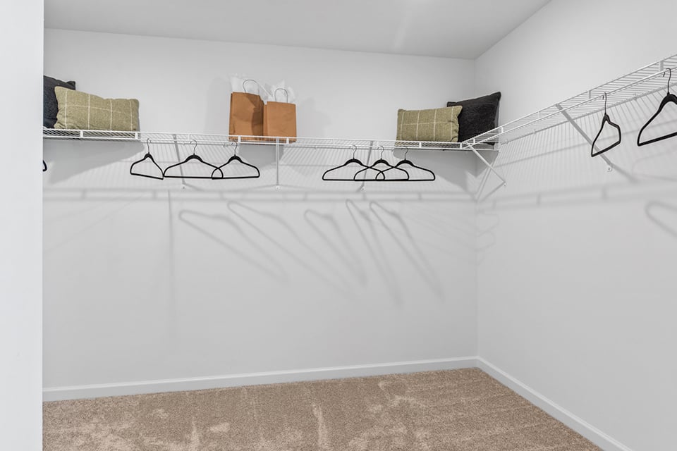 A bed with a white sheet.