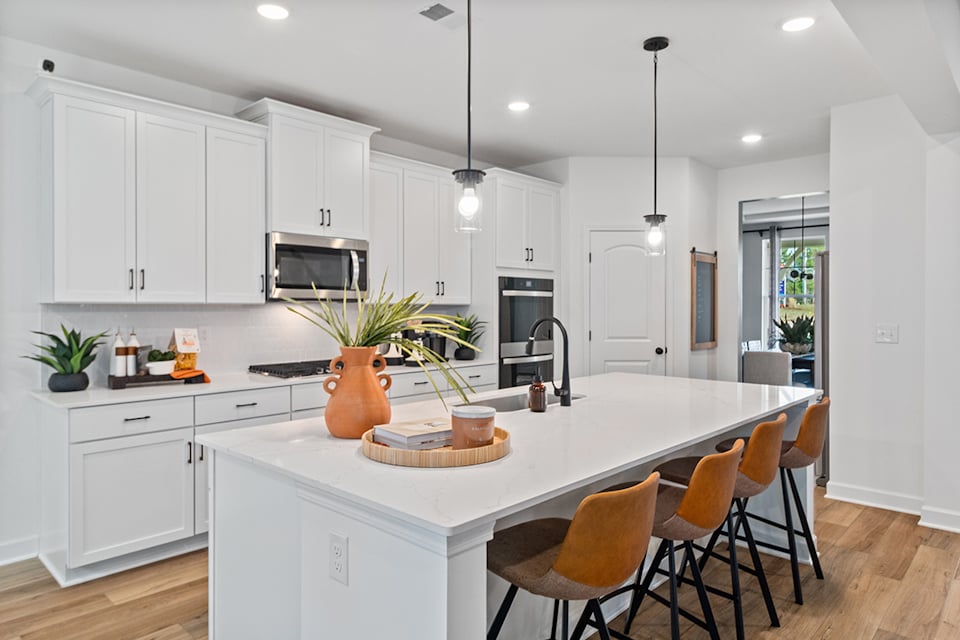 A kitchen with white cabinets.