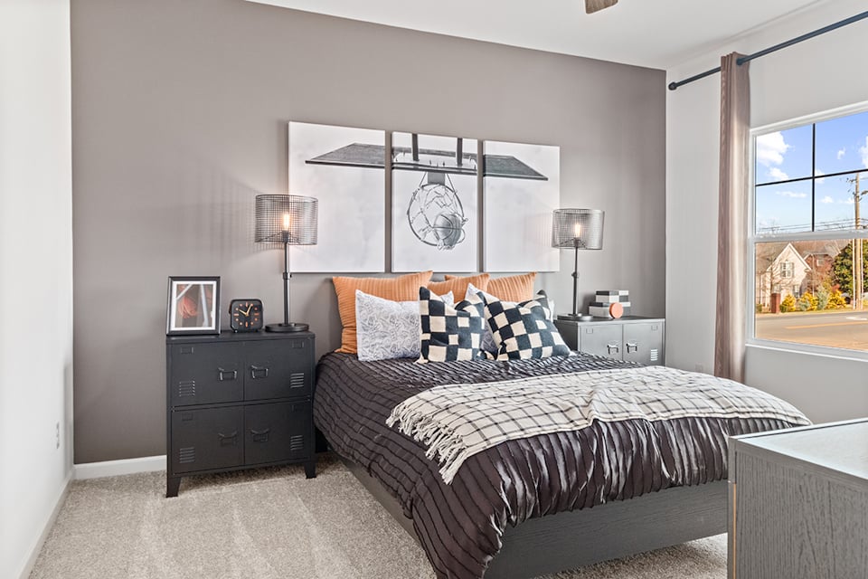 A bedroom with a large mirror.