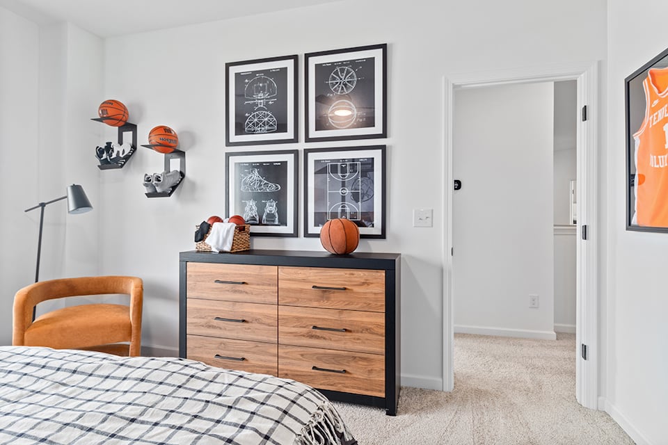 A bedroom with a bed and a dresser.