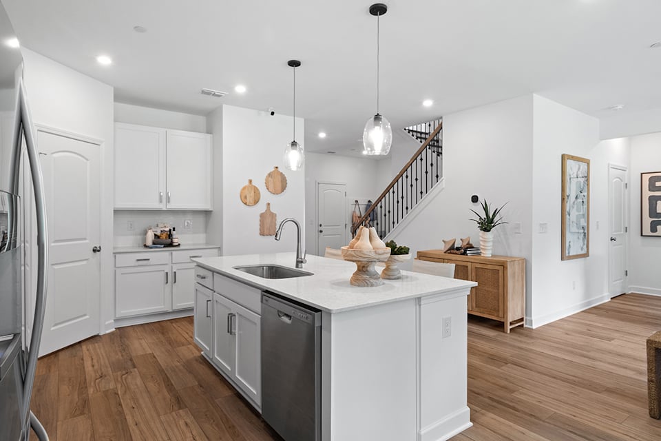 A kitchen with white cabinets.