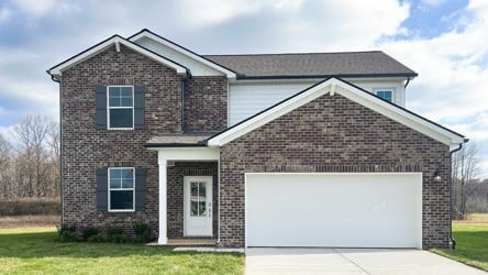 A brick house with a garage.
