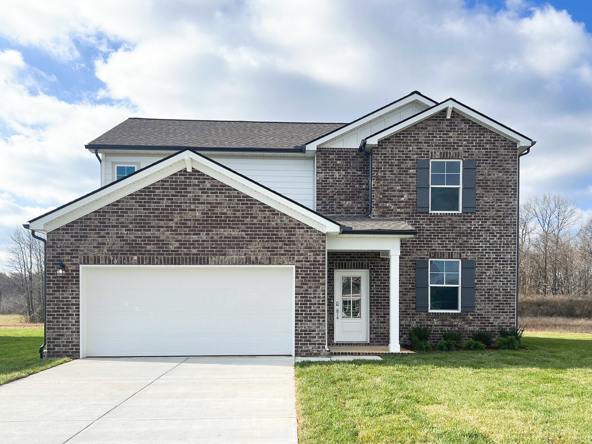 A brick house with a garage.