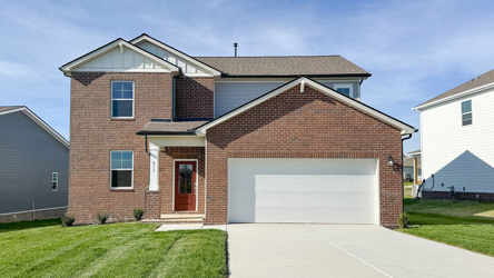 A brick house with a garage.