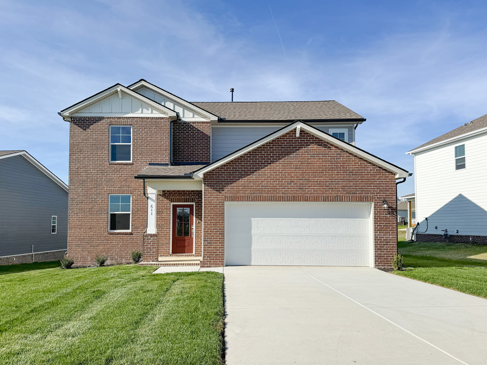 A brick house with a garage.