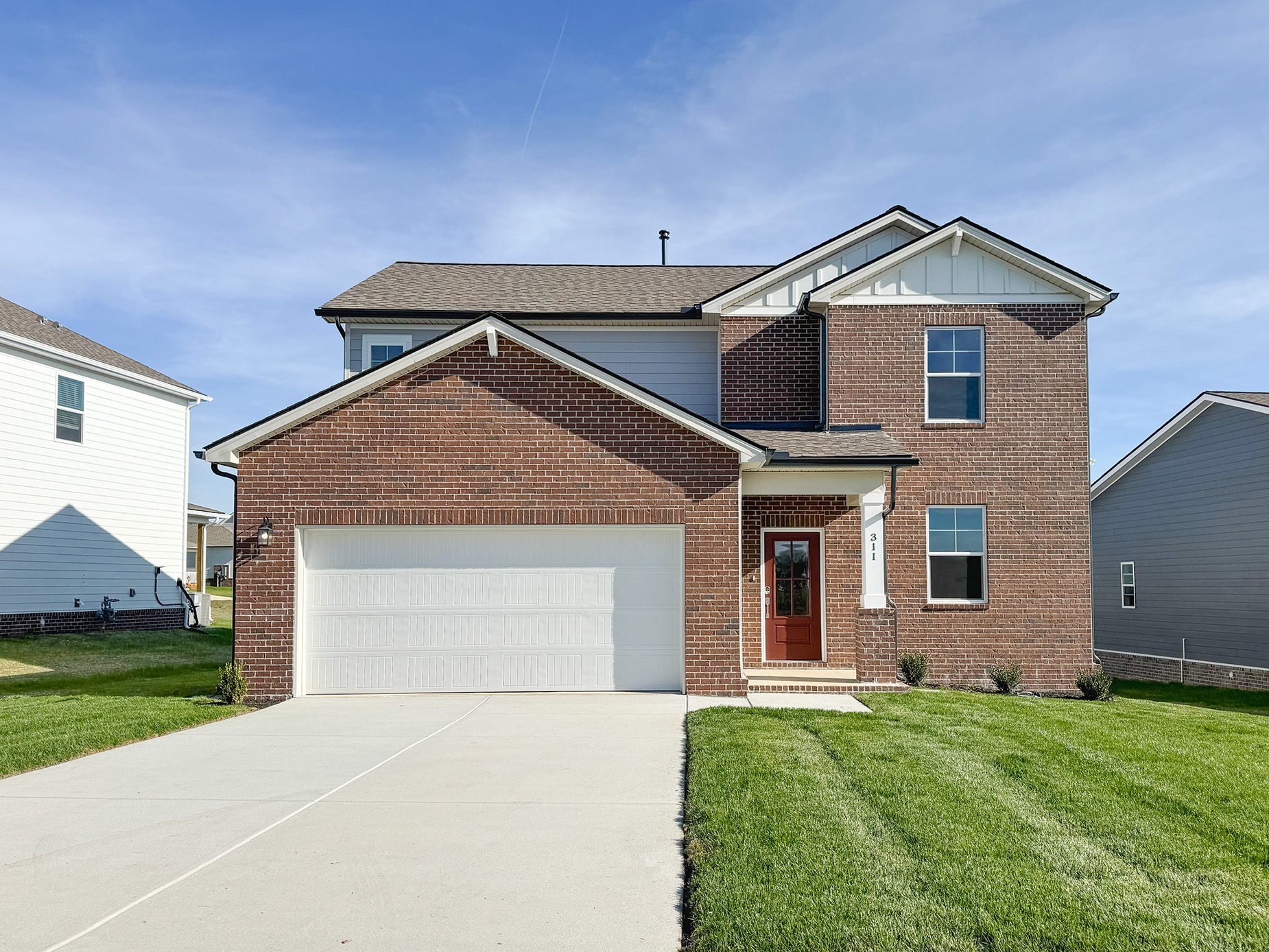 A brick house with a garage.