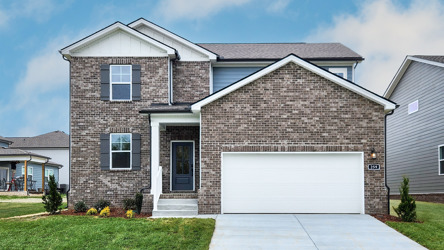 A brick house with a garage.