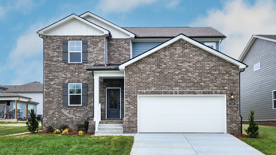 A brick house with a garage.
