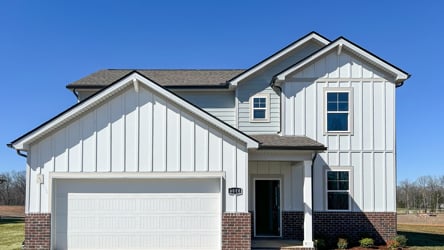 A white house with a garage.