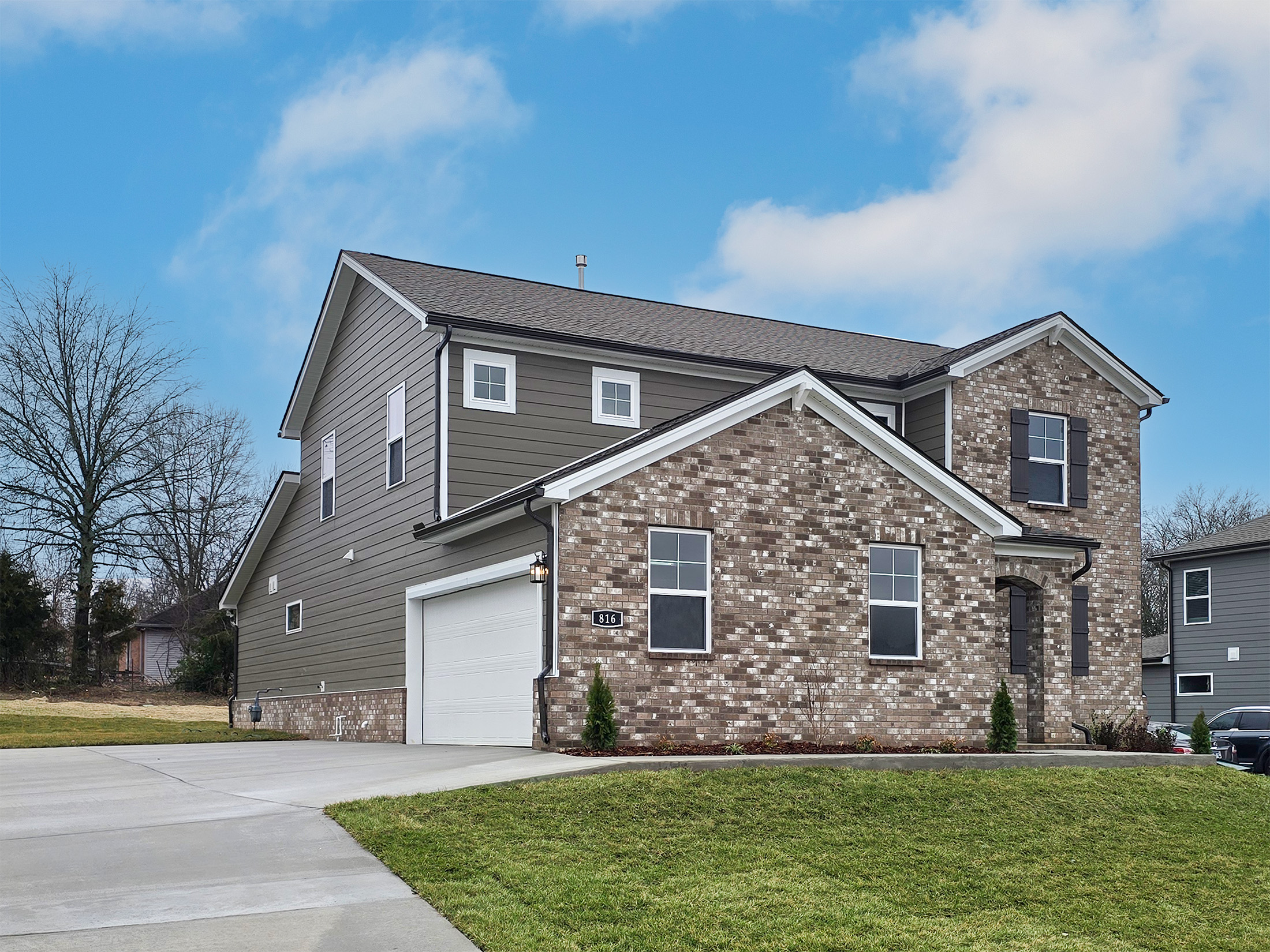 A brick house with a garage.