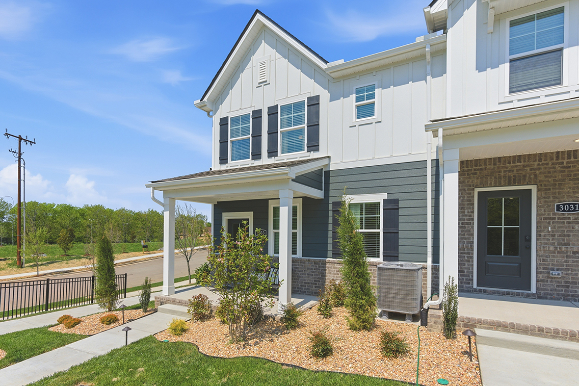 A house with a lawn and a fence.