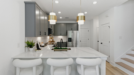 A kitchen with white cabinets.