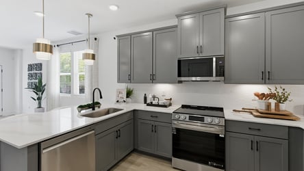 A kitchen with white cabinets.