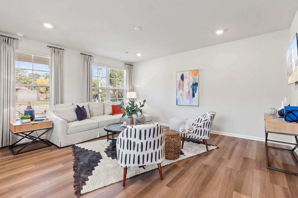 A living room with a wood floor.