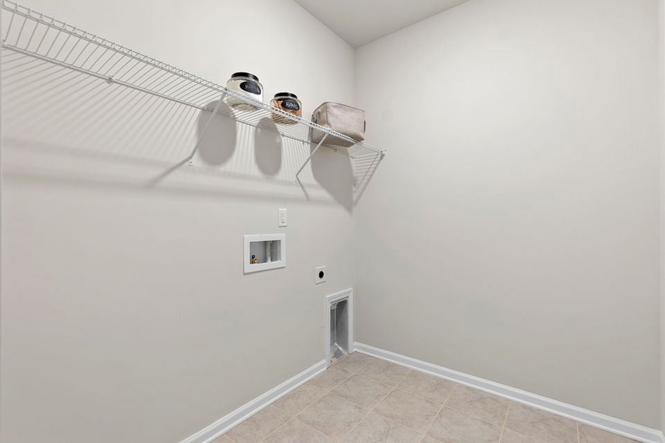 A white room with a light from the ceiling.
