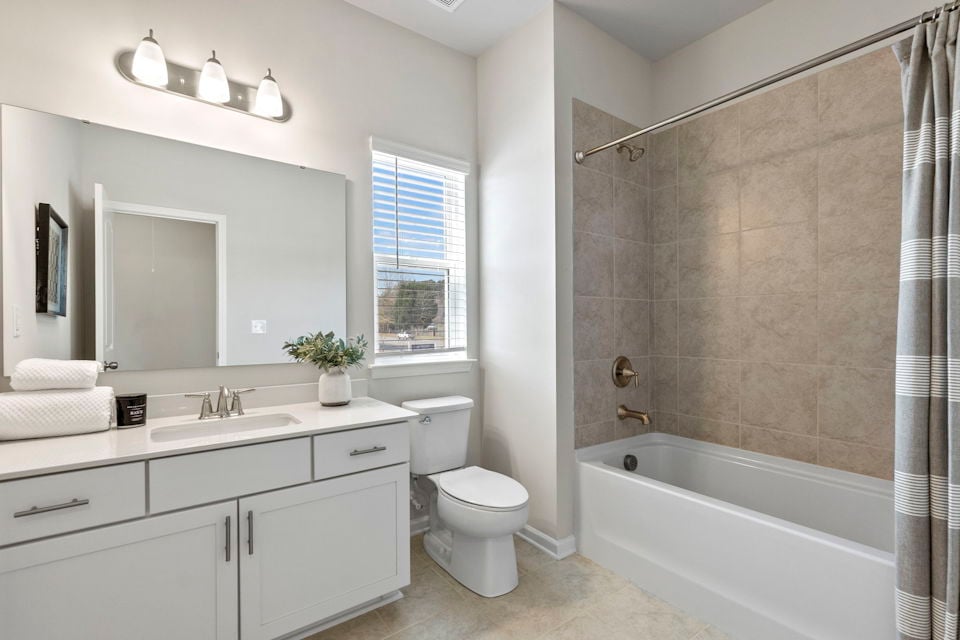 A bathroom with a tub toilet and sink.