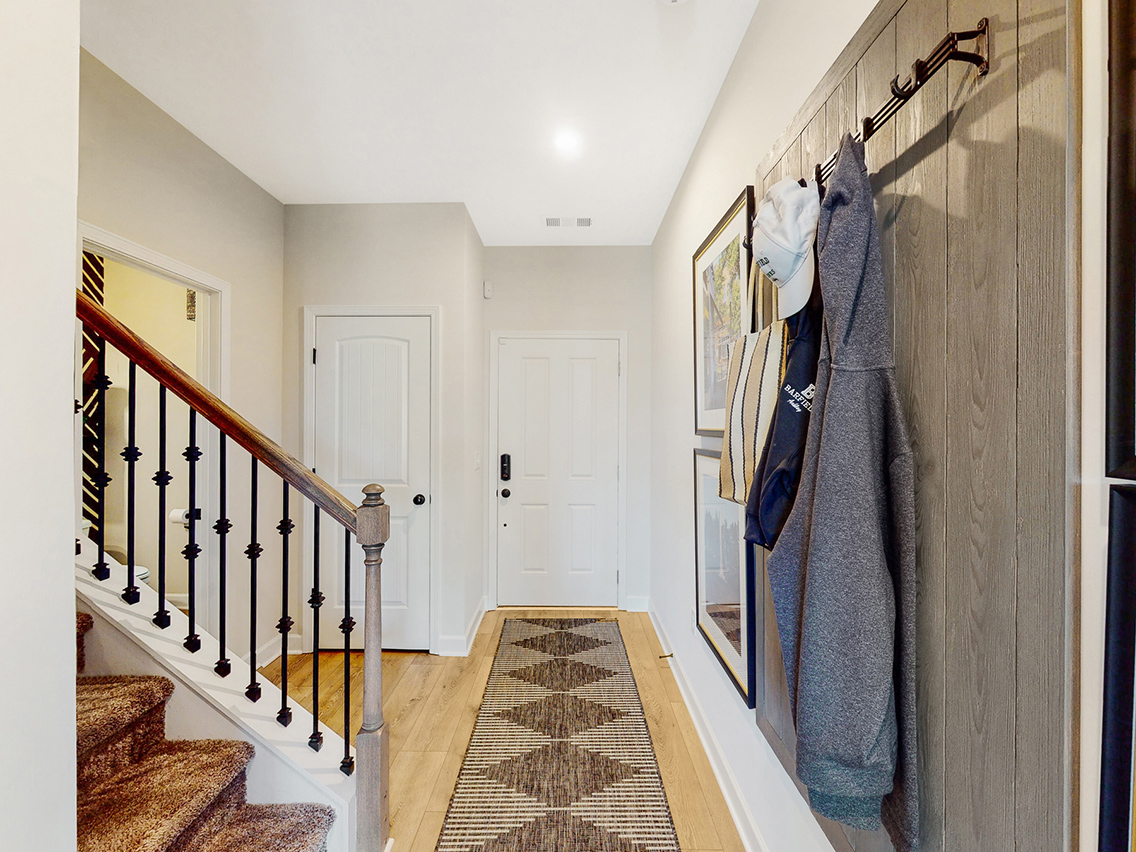 A hallway with a rug and a rug.