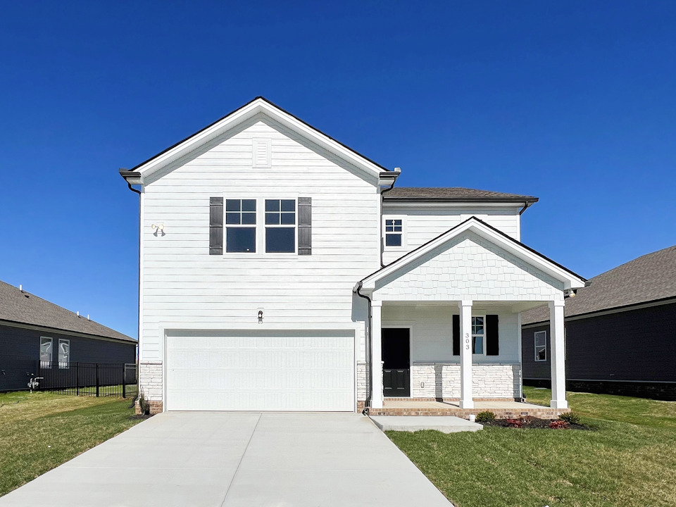 A white house with a garage.