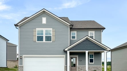 A grey house with a garage.