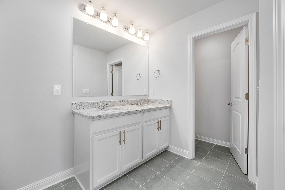 A bathroom with a marble countertop.