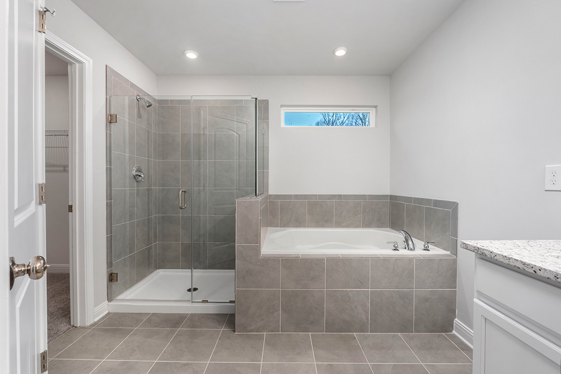 A bathroom with a tub and shower.