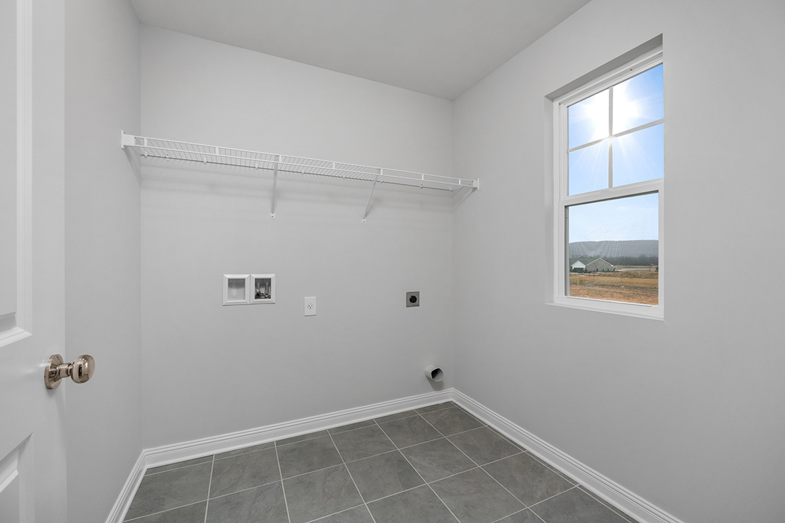 A room with a window and a tile floor.