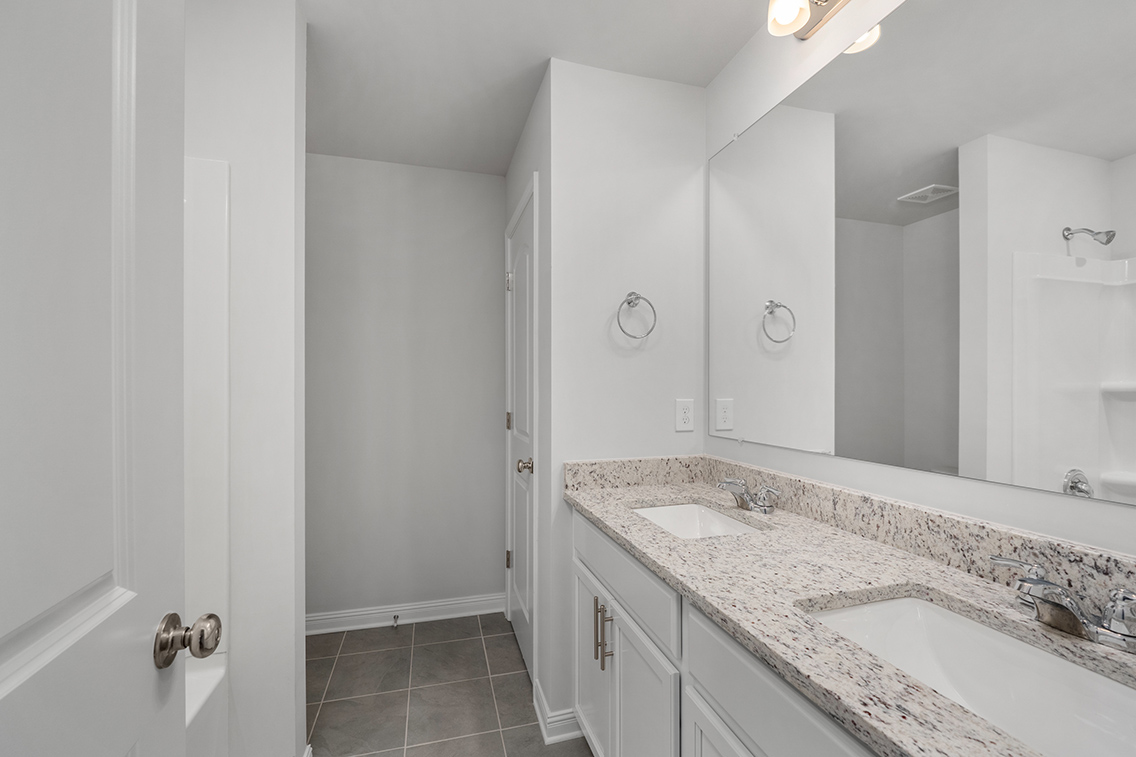 A bathroom with a large mirror.