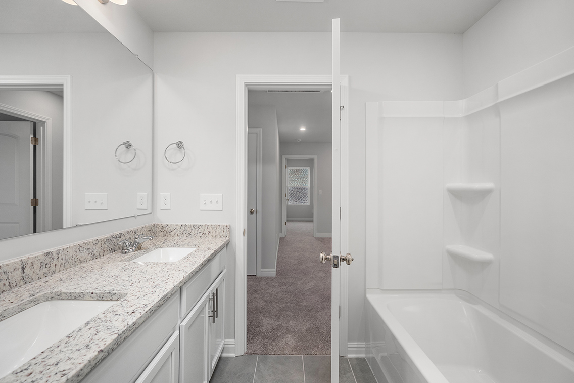 A bathroom with a marble countertop.