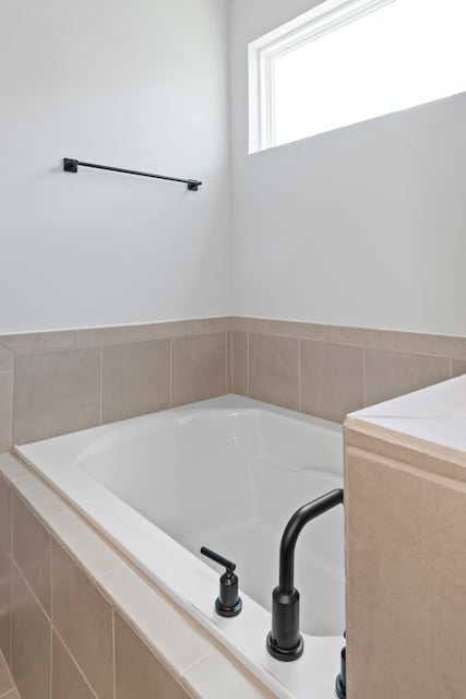 A bathtub in a bathroom.
