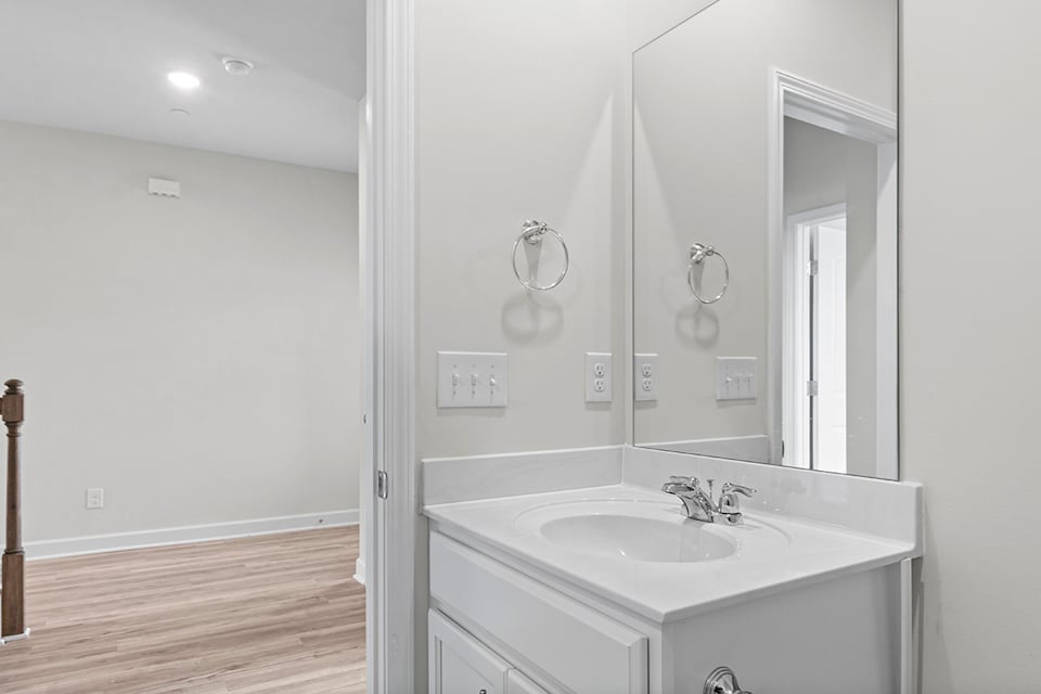 A bathroom with a large mirror.