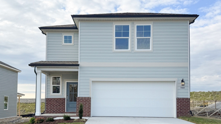 A white house with a garage.