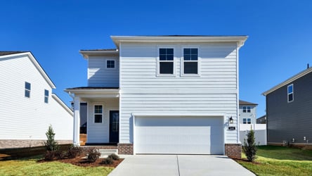 A white house with a garage.