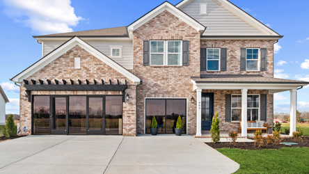 A brick building with a front yard.