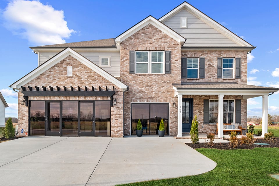 A brick building with a front yard.
