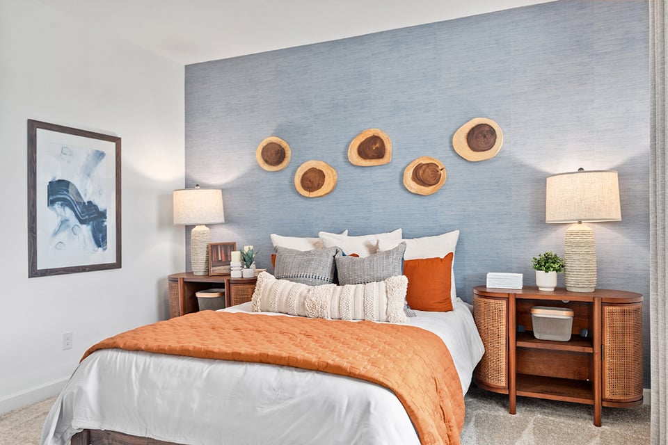 A bed with a blue wall.