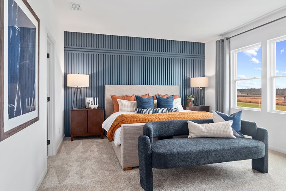 A bedroom with a bed and a couch.