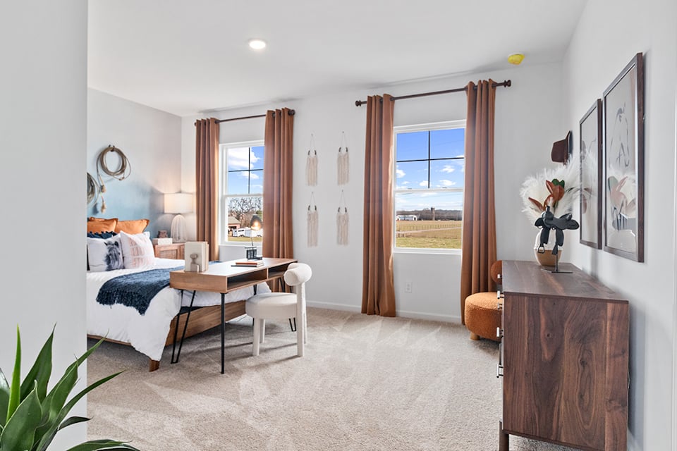 A bedroom with a large window.